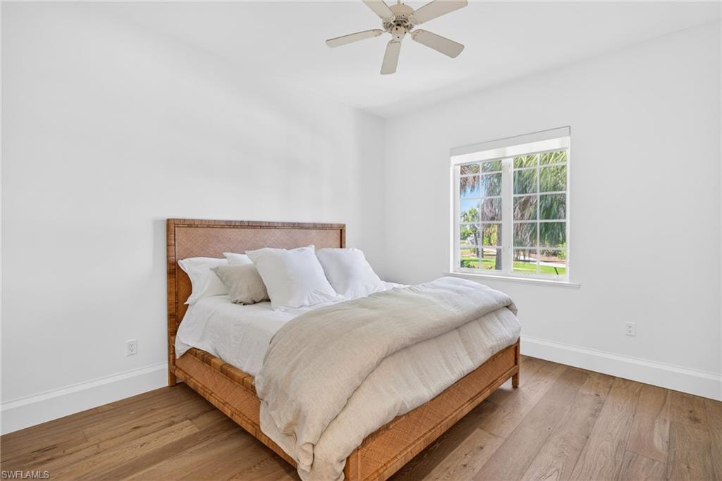 Bedroom with wood-type flooring and a ceiling fan