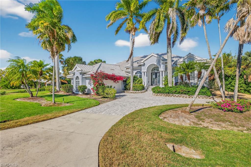 View of front of house featuring stucco siding, a front lawn, decorative driveway, an attached garage, and a tile roof