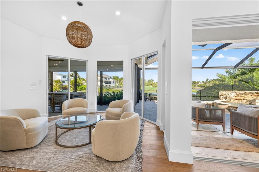 Sitting room featuring a sunroom, wood finished floors, and recessed lighting