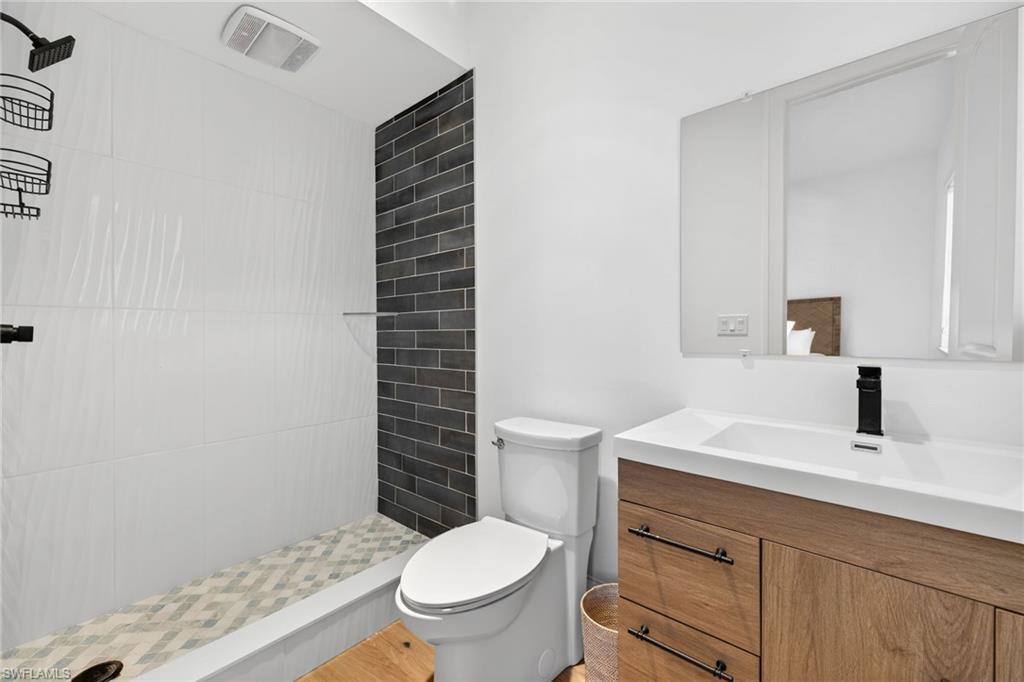 Bathroom featuring a shower stall and vanity