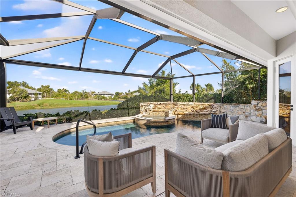 View of patio / terrace with glass enclosure, a sunroom, a water view, and a pool with connected hot tub