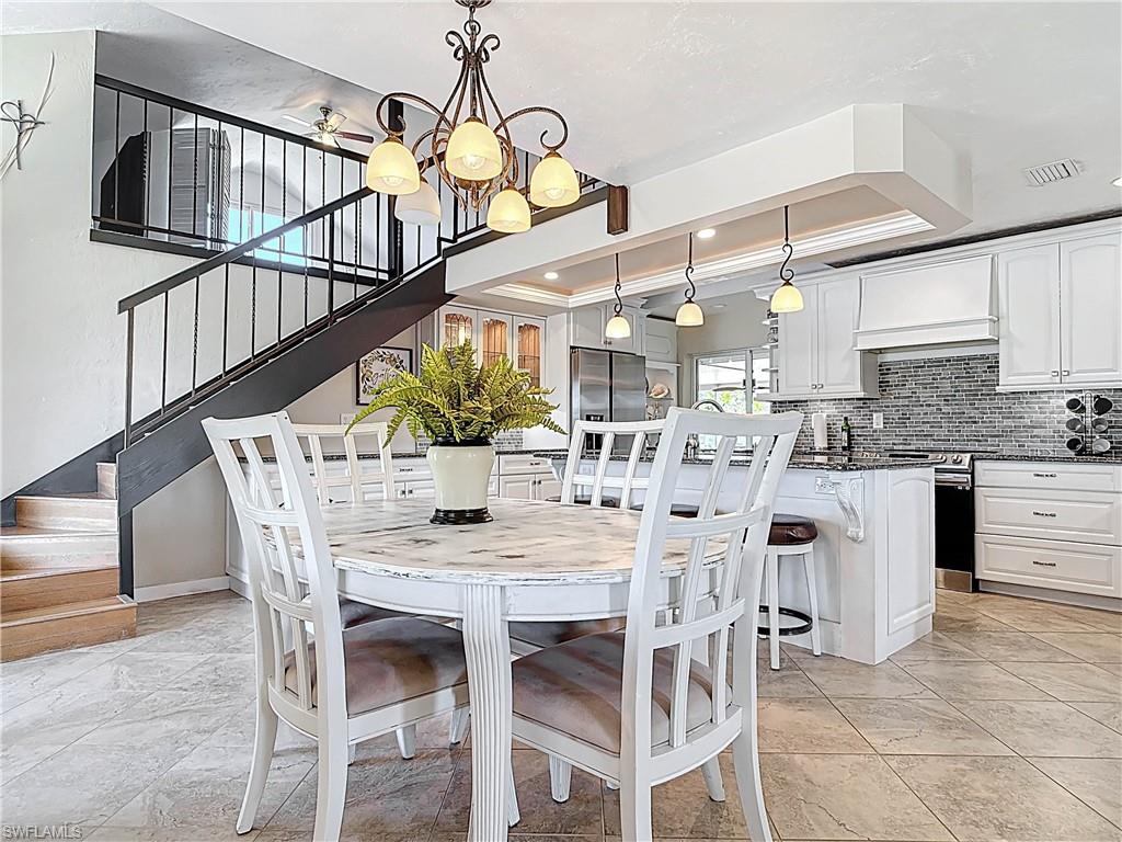 Dining area with stairway and a chandelier