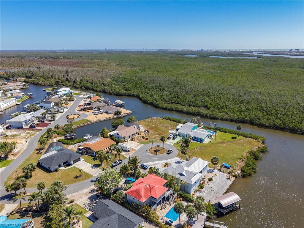 Bird's eye view of a heavily wooded area and a nearby body of water