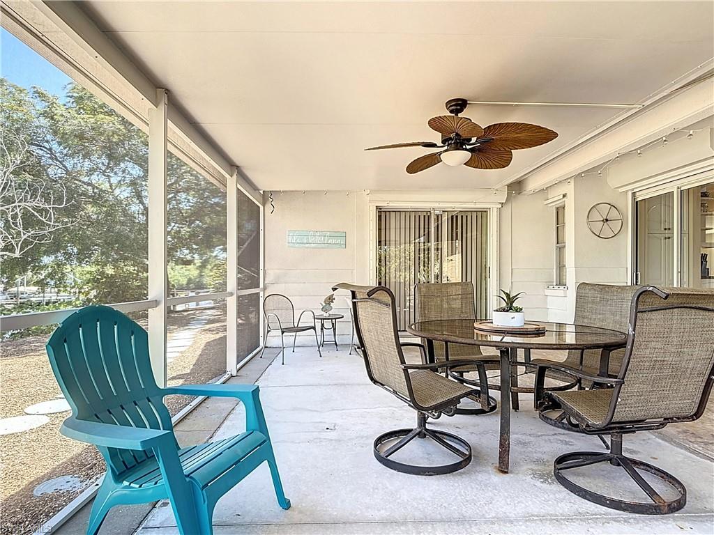 Sunroom / solarium with outdoor dining space and ceiling fan