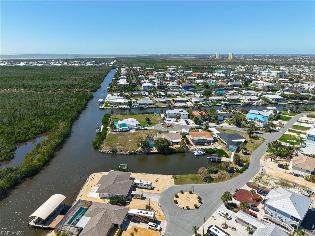 Aerial overview of property's location featuring a nearby body of water and nearby suburban area