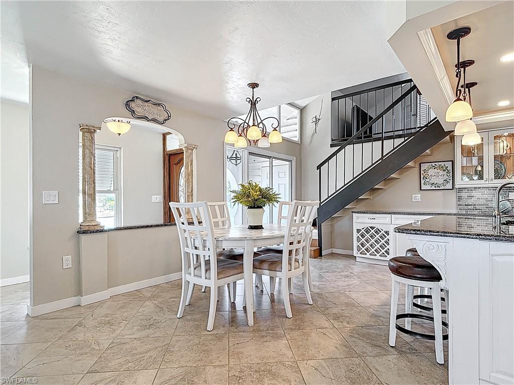 Dining room with a chandelier and stairs