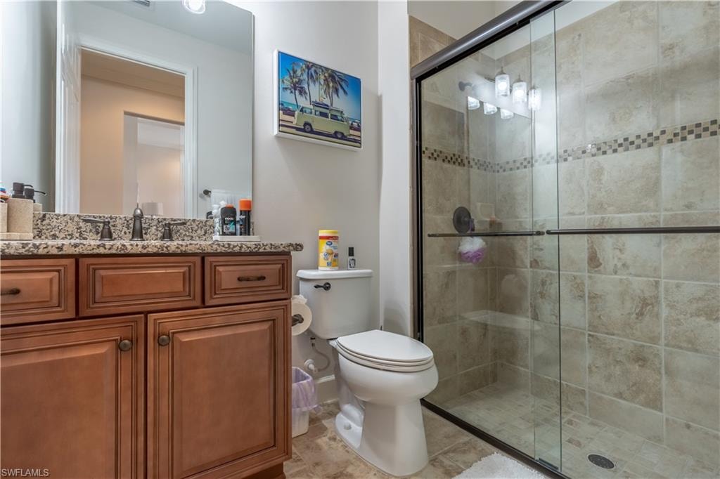 Full bathroom with vanity and a shower stall