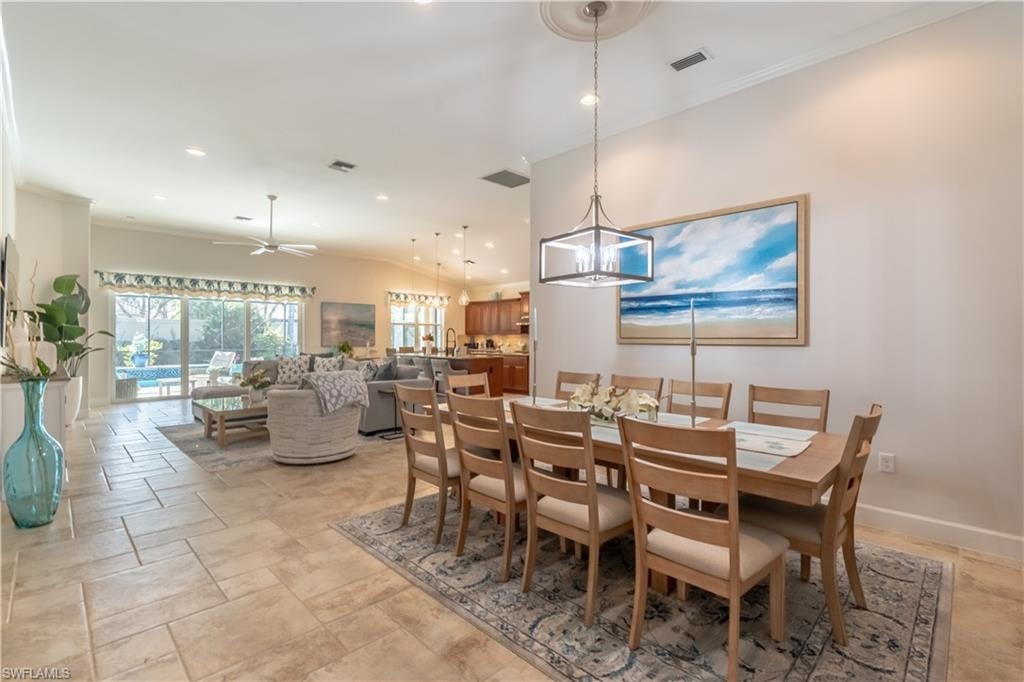 Dining room featuring ornamental molding, ceiling fan, recessed lighting, and stone tile flooring