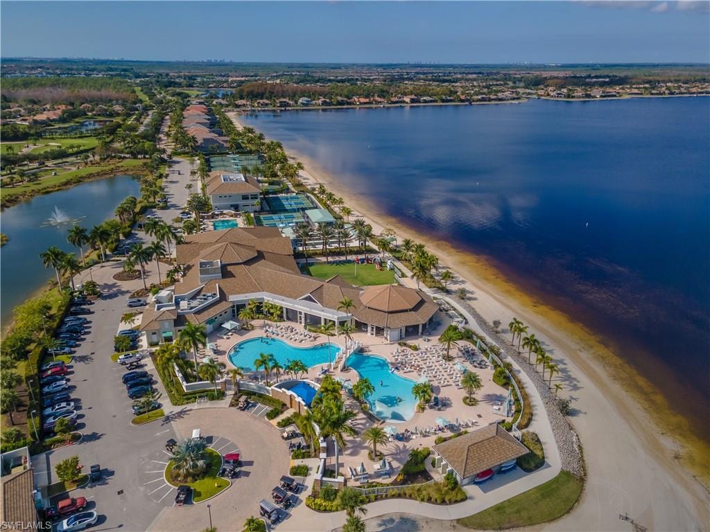 Bird's eye view of a pool area and a nearby body of water