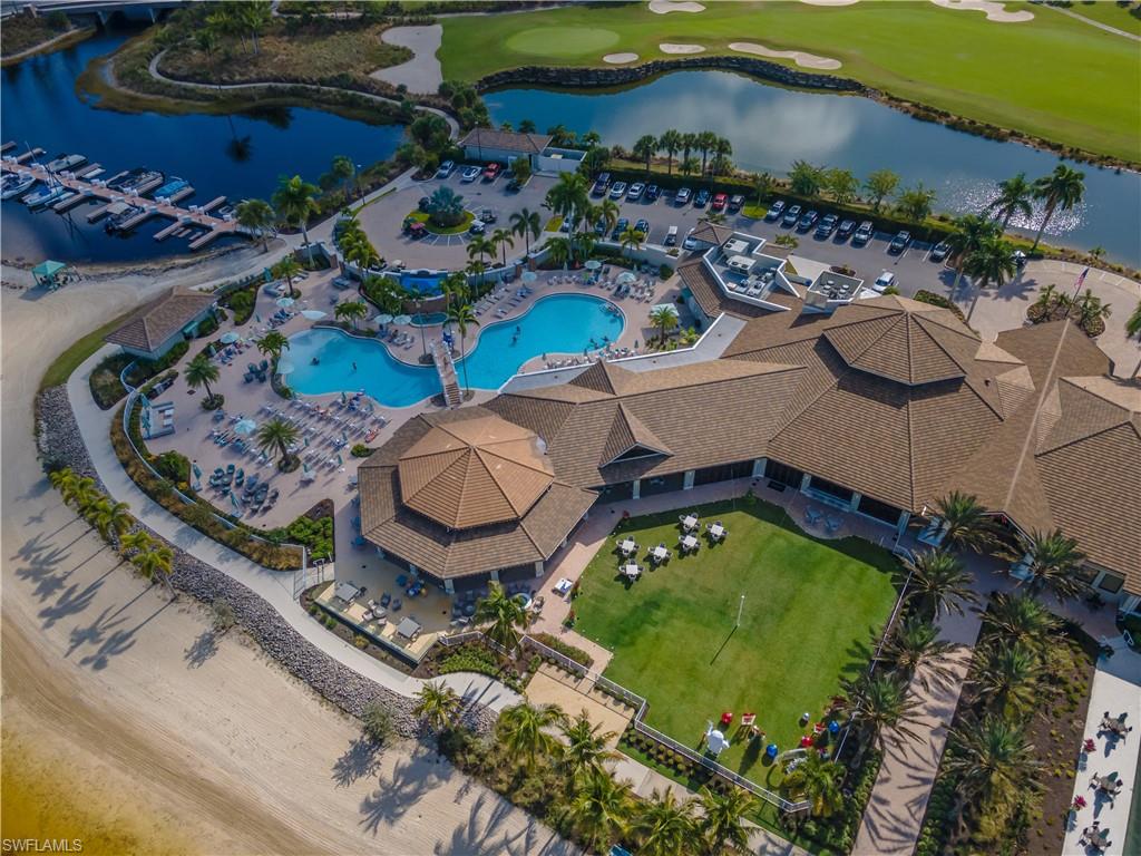 Bird's eye view of a golf course and a nearby body of water
