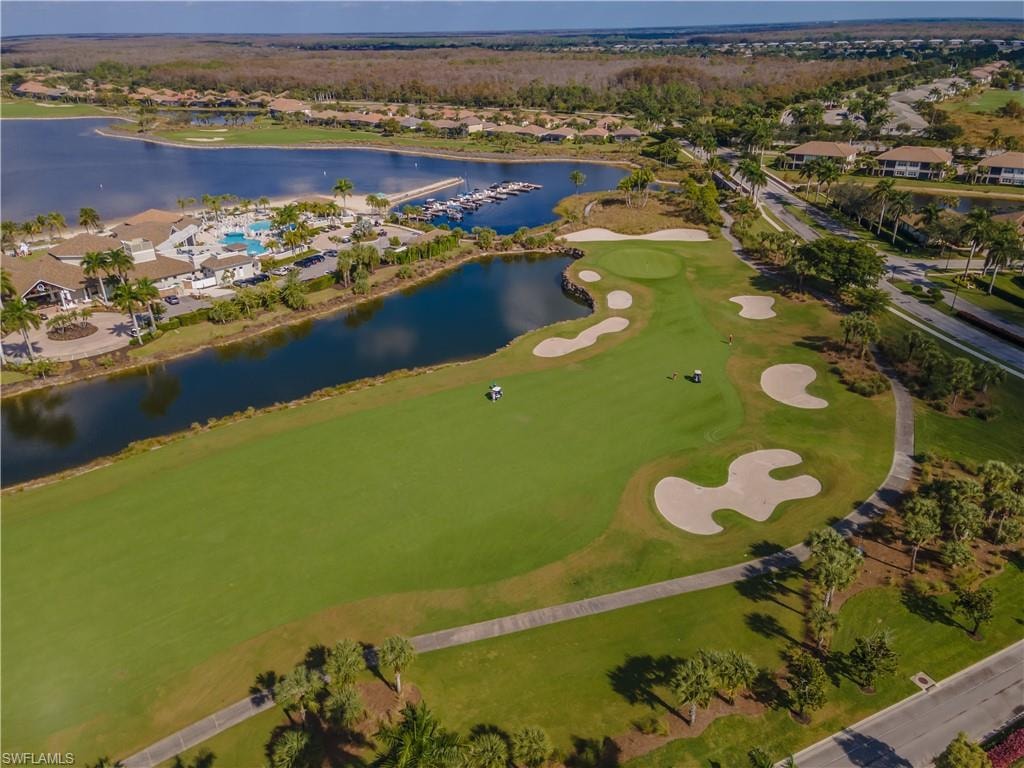 Aerial overview of property's location with a nearby body of water, a golf club, and nearby suburban area