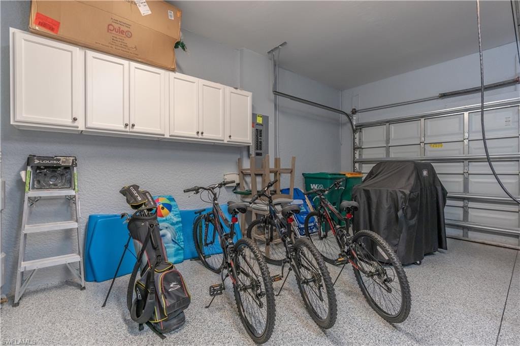 Garage with electric panel and a textured wall
