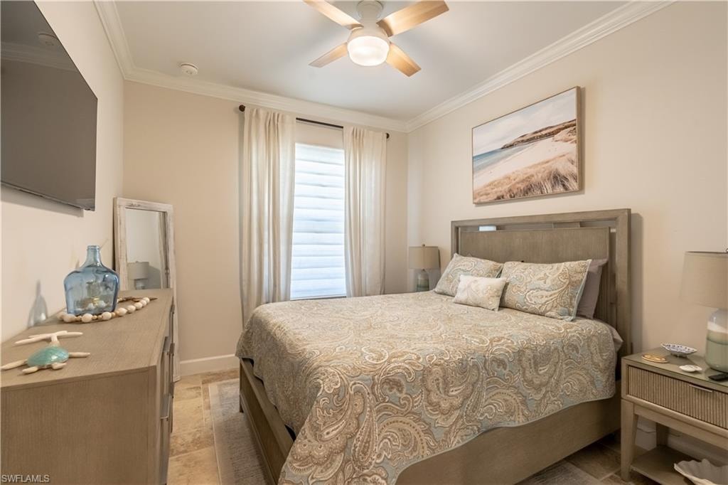 Bedroom with crown molding and a ceiling fan