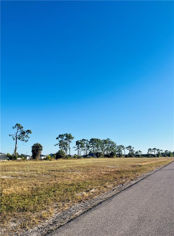 View of asphalt road with a view of rural / pastoral area