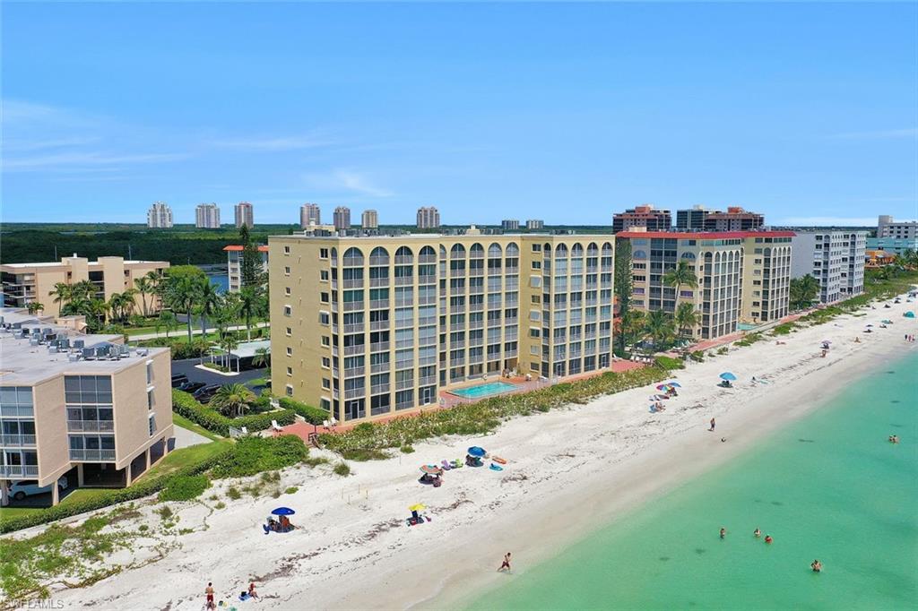 Bird's eye view of apartment complex / building and waterfront with a beach