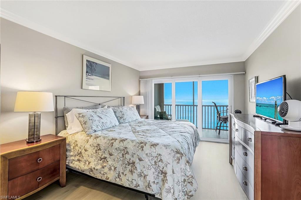 Bedroom featuring access to outside and crown molding
