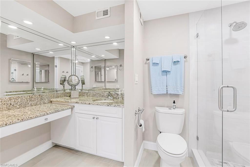 Full bathroom with vanity, a stall shower, and recessed lighting