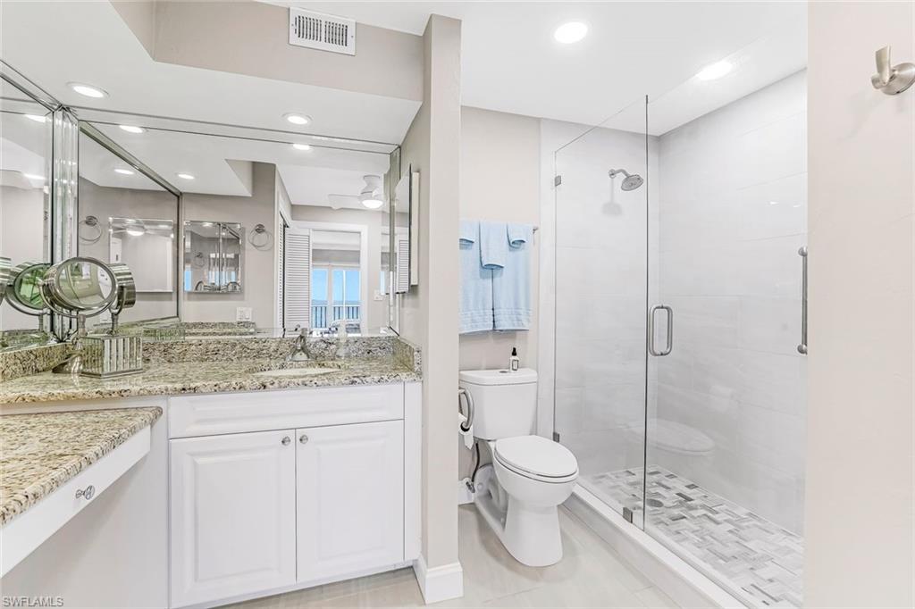 Bathroom featuring vanity, a stall shower, and recessed lighting