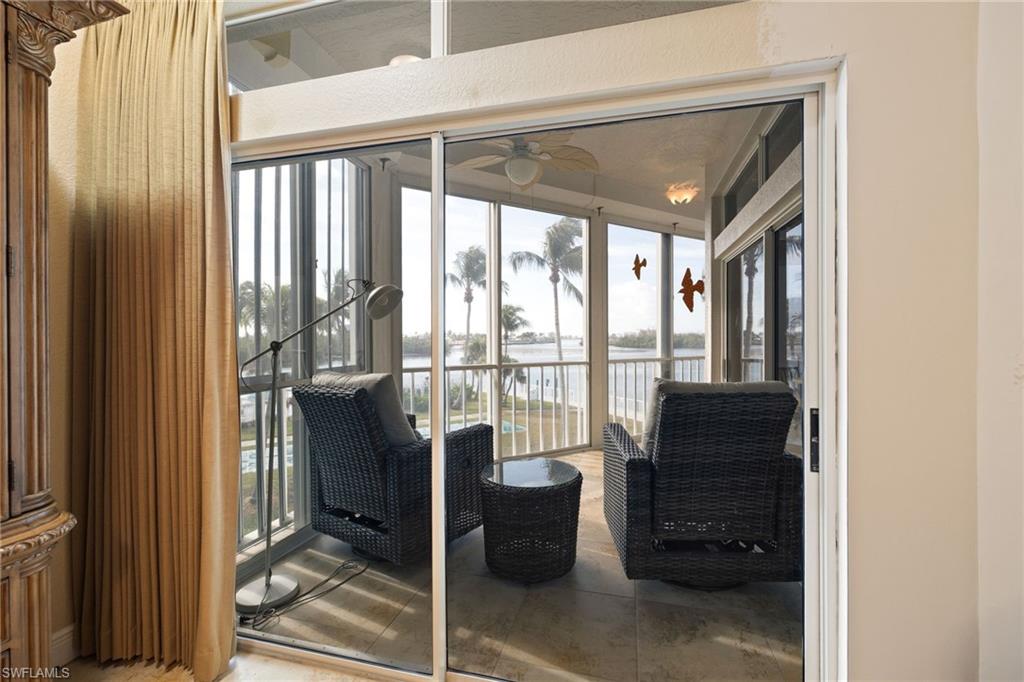 Sunroom / solarium with a water view and healthy amount of natural light
