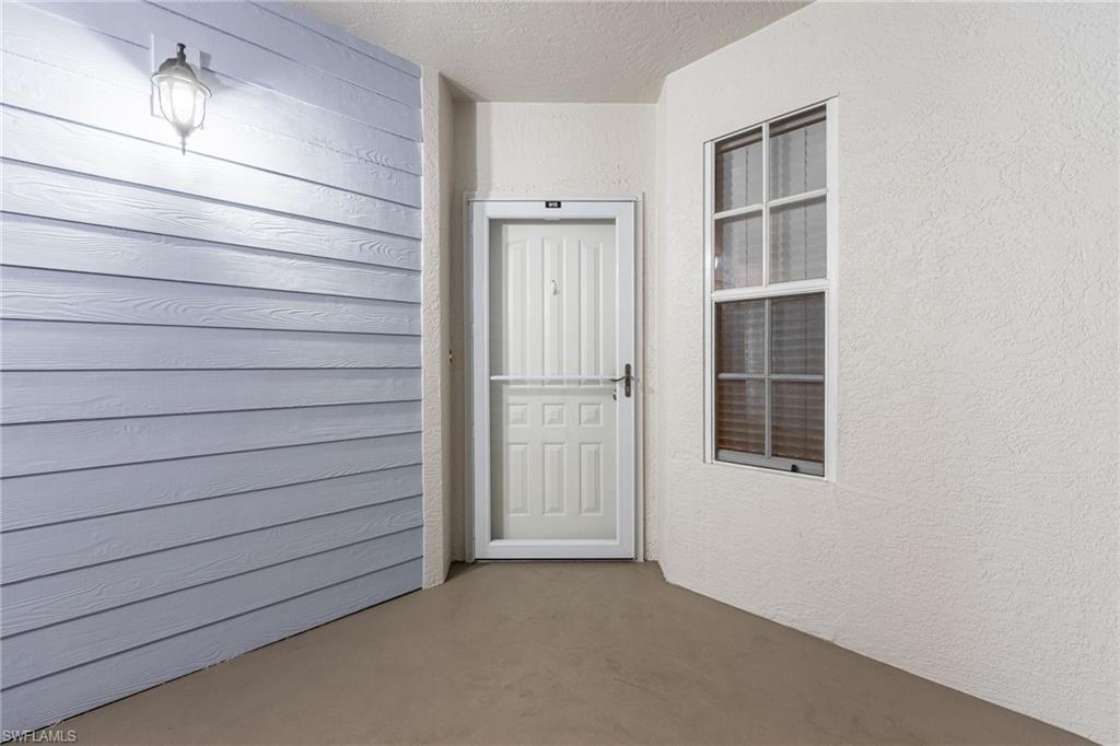 Property entrance featuring stucco siding