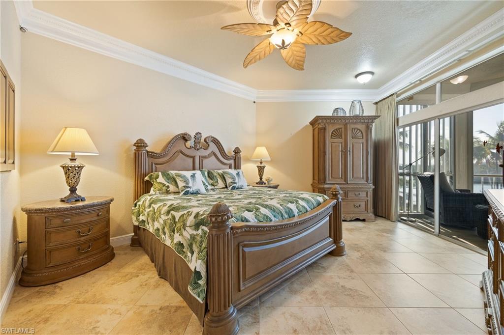 Bedroom featuring crown molding, access to exterior, ceiling fan, and light tile patterned floors