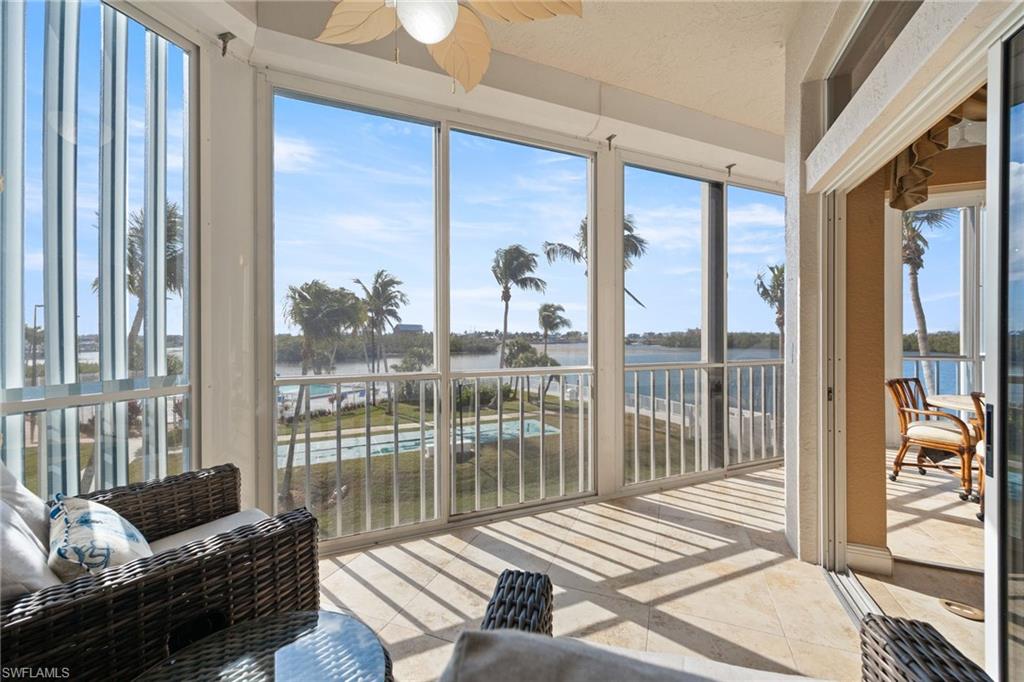 Sunroom featuring a water view, healthy amount of natural light, and tile patterned flooring