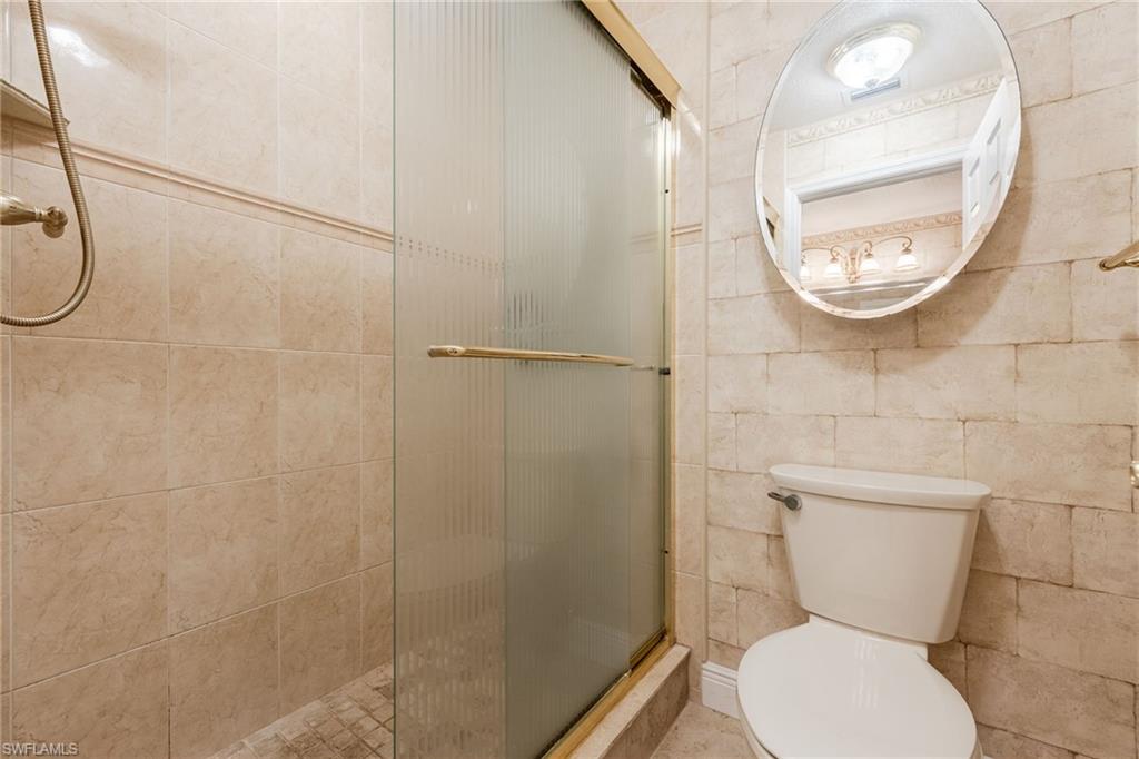 Bathroom featuring a stall shower and toilet