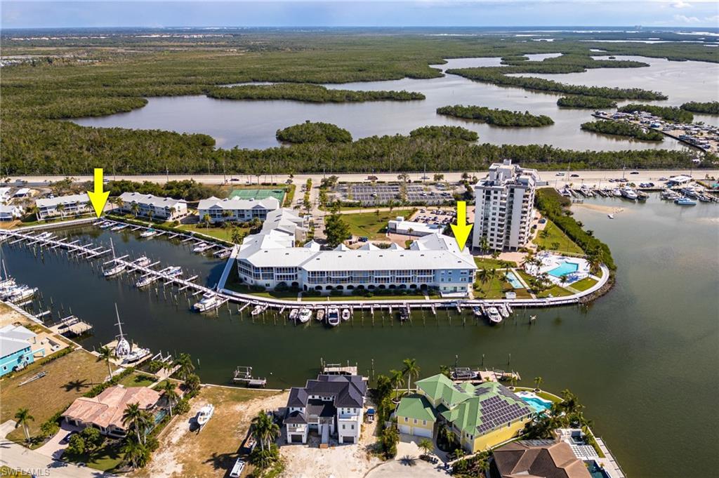 View of property location with a marina and a nearby body of water