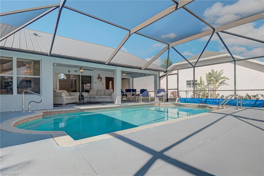 Swimming pool featuring an outdoor hangout area, a lanai, a patio, and a sunroom