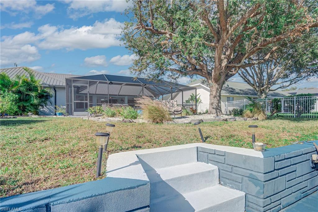 View of yard featuring a lanai, a sunroom, and a patio