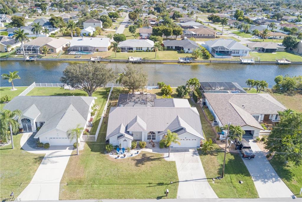 Aerial perspective of suburban area with a nearby body of water