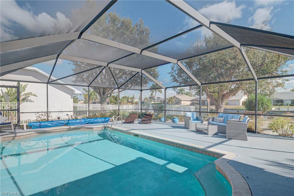 View of swimming pool with a lanai, a sunroom, a patio, and outdoor lounge area