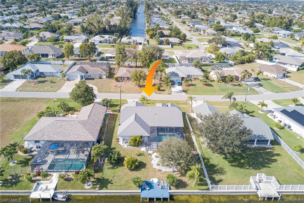 Aerial view of property's location with nearby suburban area