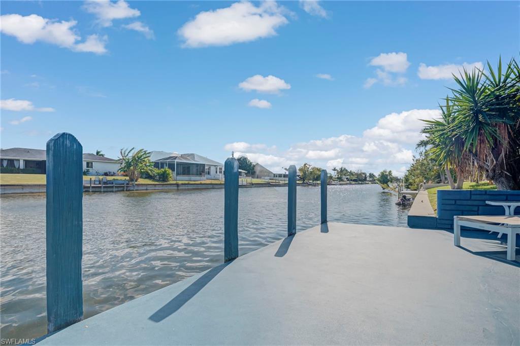 Dock area with a water view and a residential view