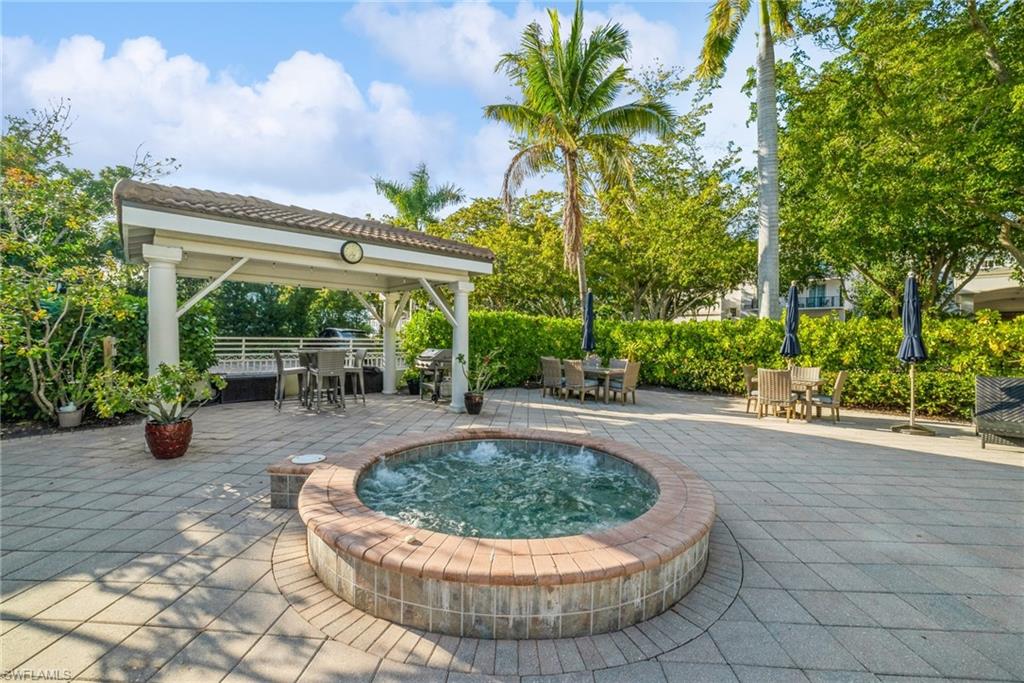 View of home's community with a patio area and a jacuzzi