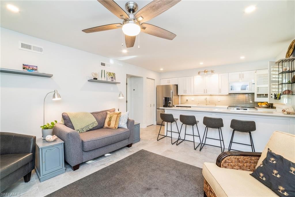 Living room with recessed lighting and ceiling fan