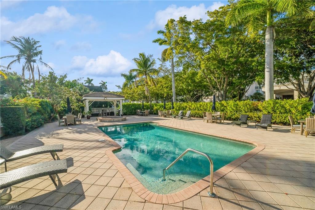 View of pool featuring a gazebo, a patio area, and an in-ground hot tub