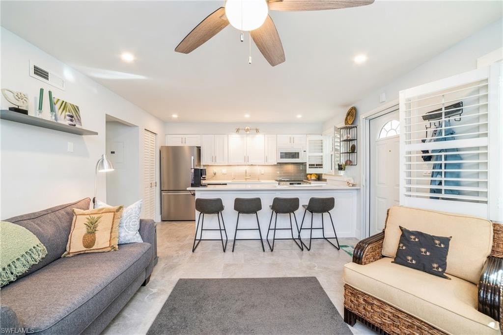Living area featuring a ceiling fan and recessed lighting