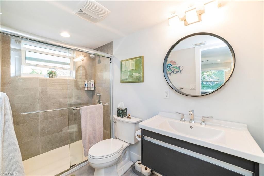 Full bath featuring vanity, a stall shower, and recessed lighting