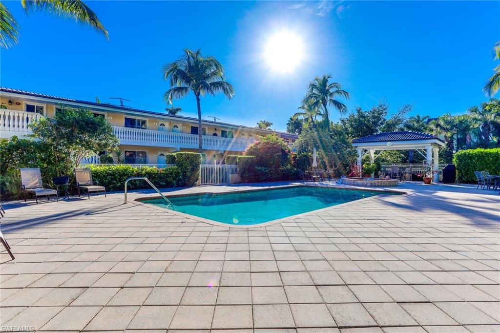 Community pool with a patio area and a gazebo