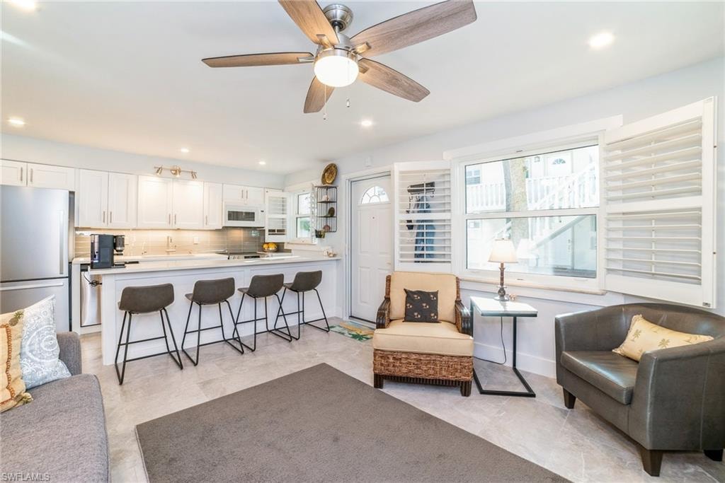 Living area with ceiling fan and recessed lighting