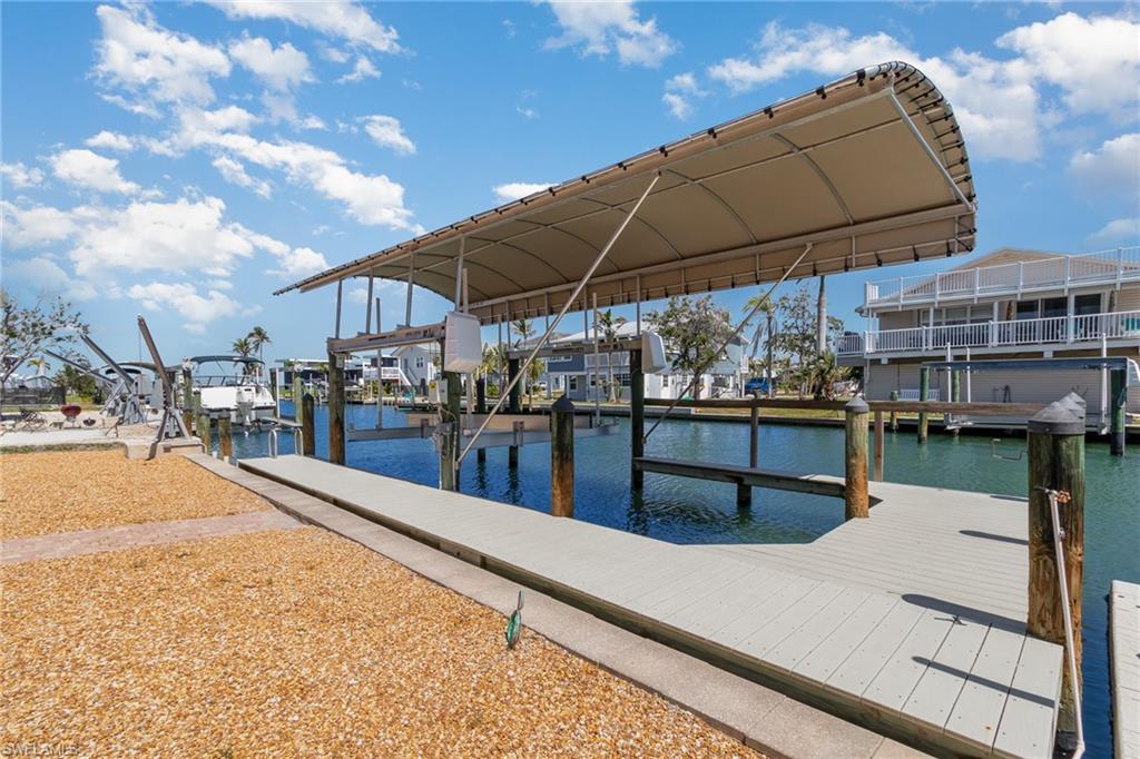 Dock featuring boat lift and a water view