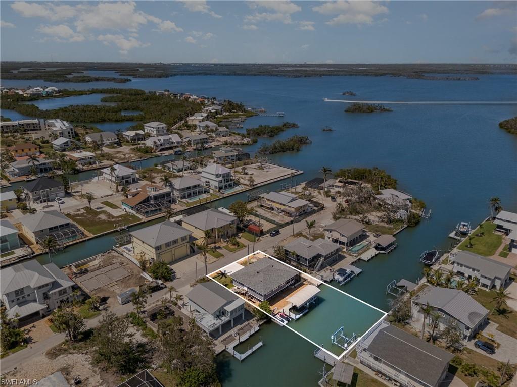 Aerial perspective of suburban area with a nearby body of water
