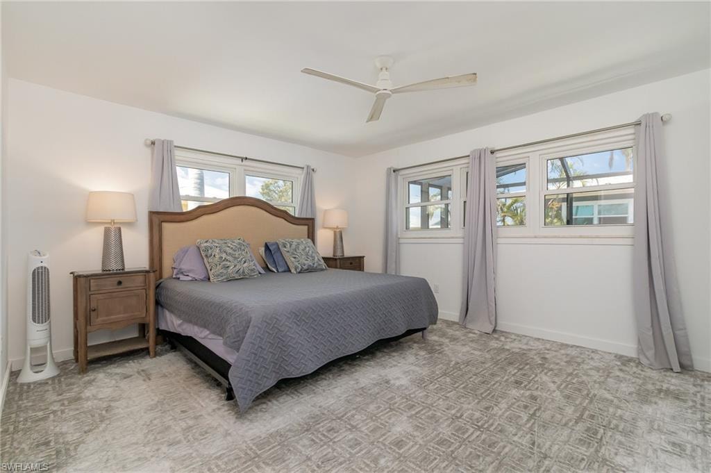 Bedroom with a ceiling fan and baseboards