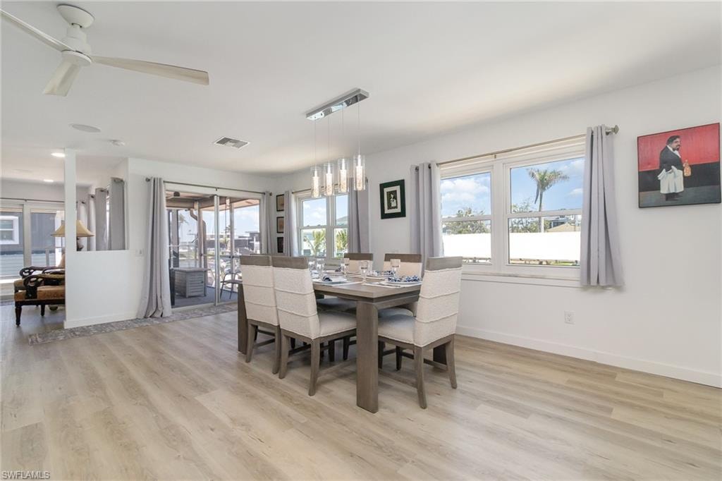 Dining space featuring light wood finished floors and a ceiling fan