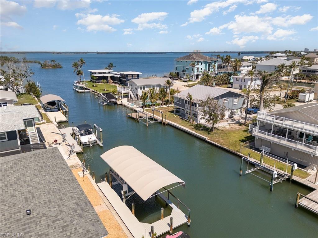 Aerial view of residential area featuring a nearby body of water