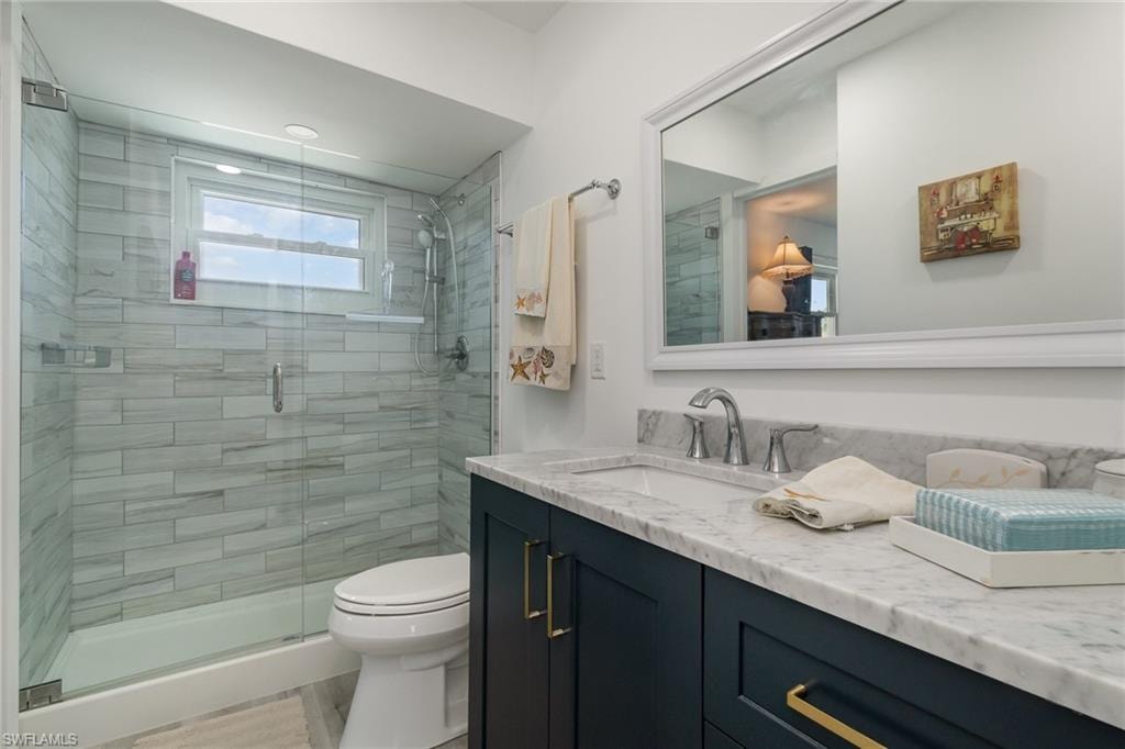 Full bath featuring vanity and a shower stall