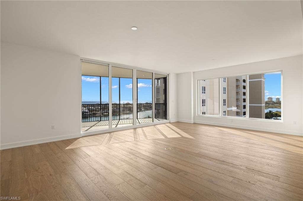 Plenty of lights fills the great room and a wall of windows for wonderful water views