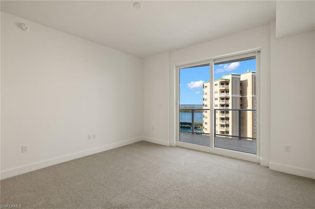 Bedroom 2 features light colored carpeting, and slider to open balcony , gorgeous bay views