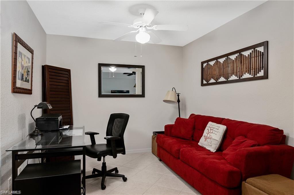 Office space with tile patterned flooring and ceiling fan